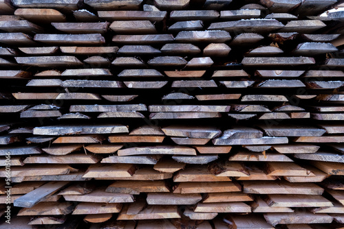 A stack of processed boards stands on the street in winter