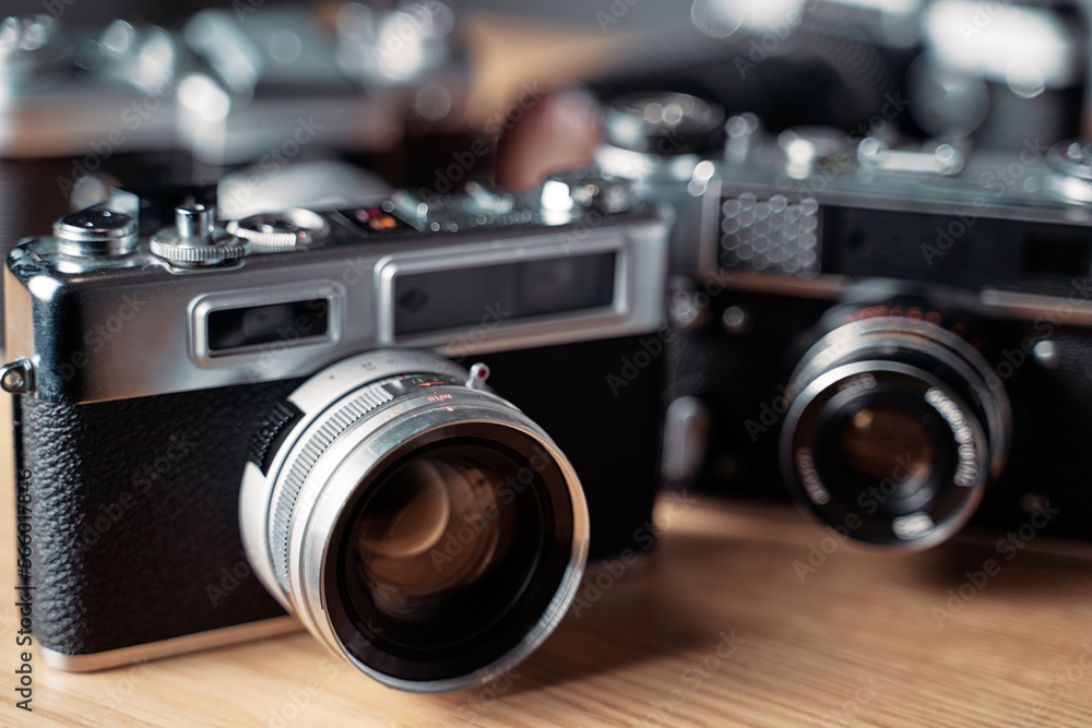 Vintage film cameras on wooden table.