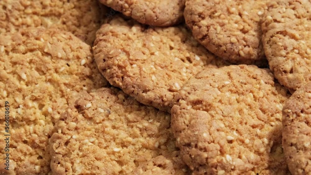Whole meal cookies. Delicious cookies with sesame seeds. Oatmeal bakery. Pile of fresh cookies. Healthy food concept. Close-up in 4K, UHD Whole meal cookies. Delicious cookies with sesame seeds. Oatmeal bakery. Pile of fresh cookies. Healthy food concept. Close-up in 4K, UHD