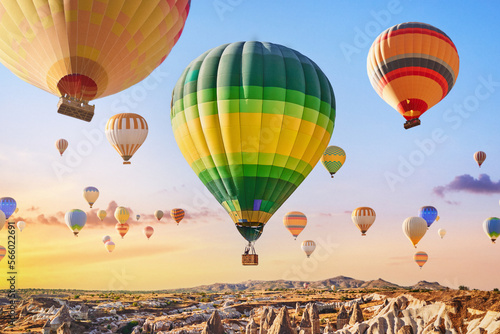 Landscape of fabulous Kapadokya. Colorful flying air balloons in sky at sunrise in Anatolia. Vacations in beautiful destination in Goreme, Turkey © Goffkein