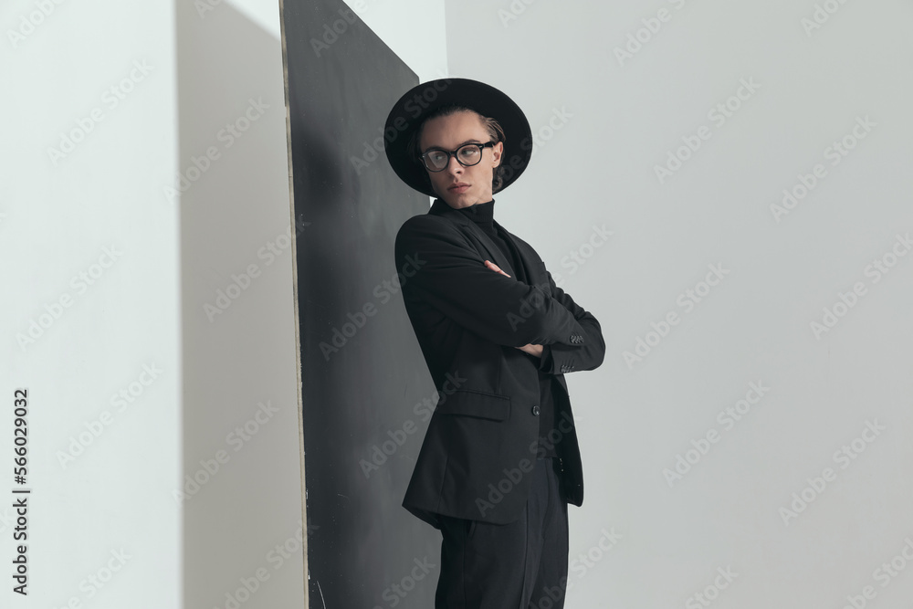 portrait of young fashion guy looking behind shoulder and posing portrait of young fashion guy looking behind shoulder and posing