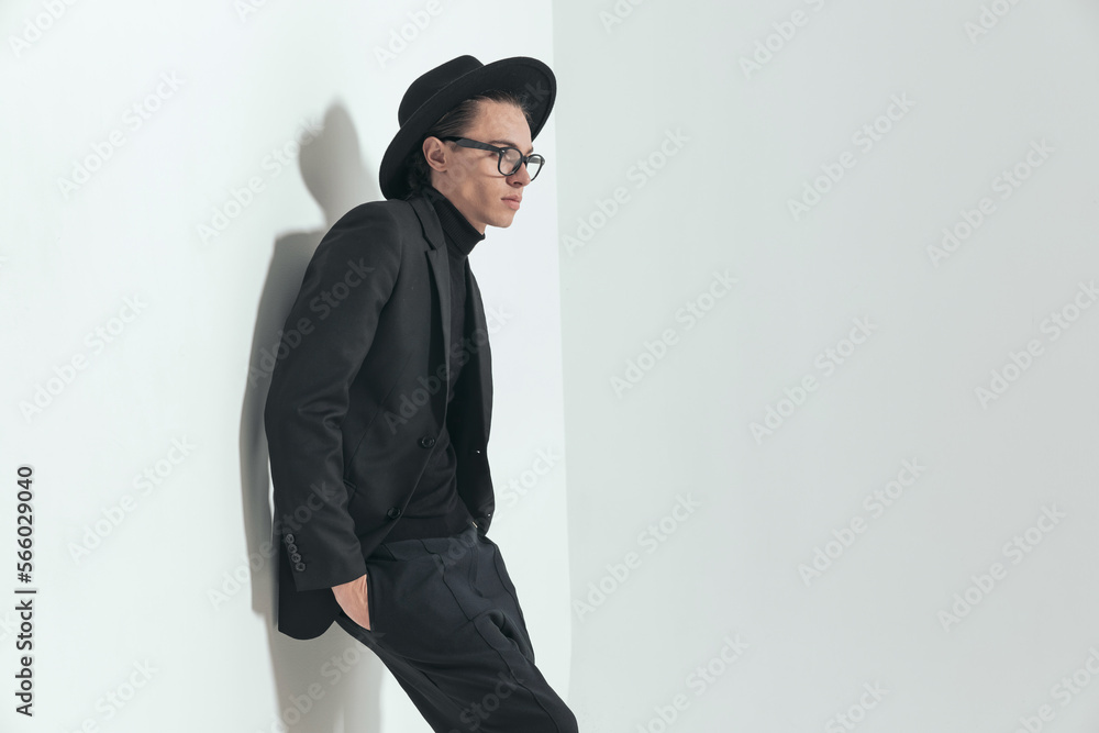side view of fashion guy with hat and glasses looking to side side view of fashion guy with hat and glasses looking to side
