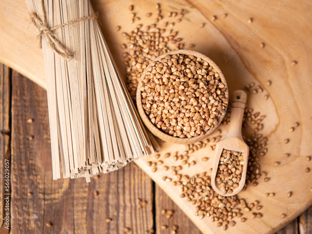 buckwheat noodles and buckwheat groats on a wooden background, rustic composition with buckwheat buckwheat noodles and buckwheat groats on a wooden background, rustic composition with buckwheat