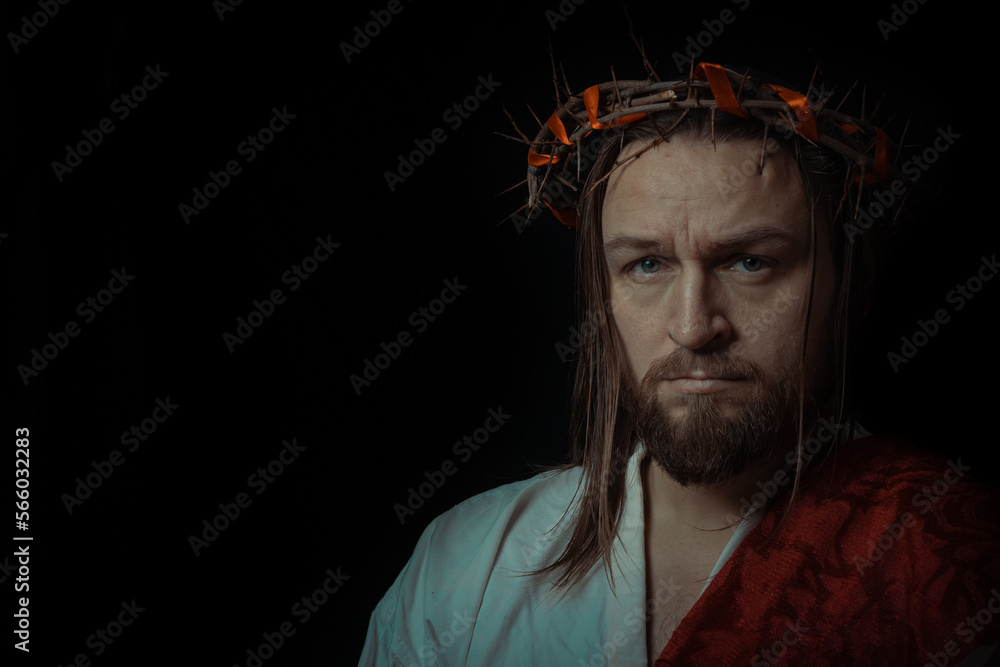 Fototapeta premium Jesus Christ wearing a crown of thorns and white chiton toga mantle cape himation suffering for mankind's sins in artistic mystical portrait