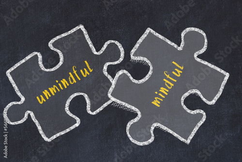 Concept of dealing with troubles. Chalk sketch of connecting puzzles with words unmindful and mindful
