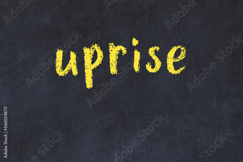 College chalk desk with the word uprise written on in