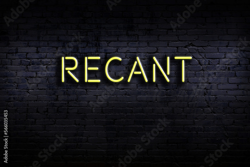 Neon sign. Word recant against brick wall. Night view photo