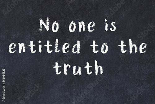 Chalk wise inscription on black chalkboard