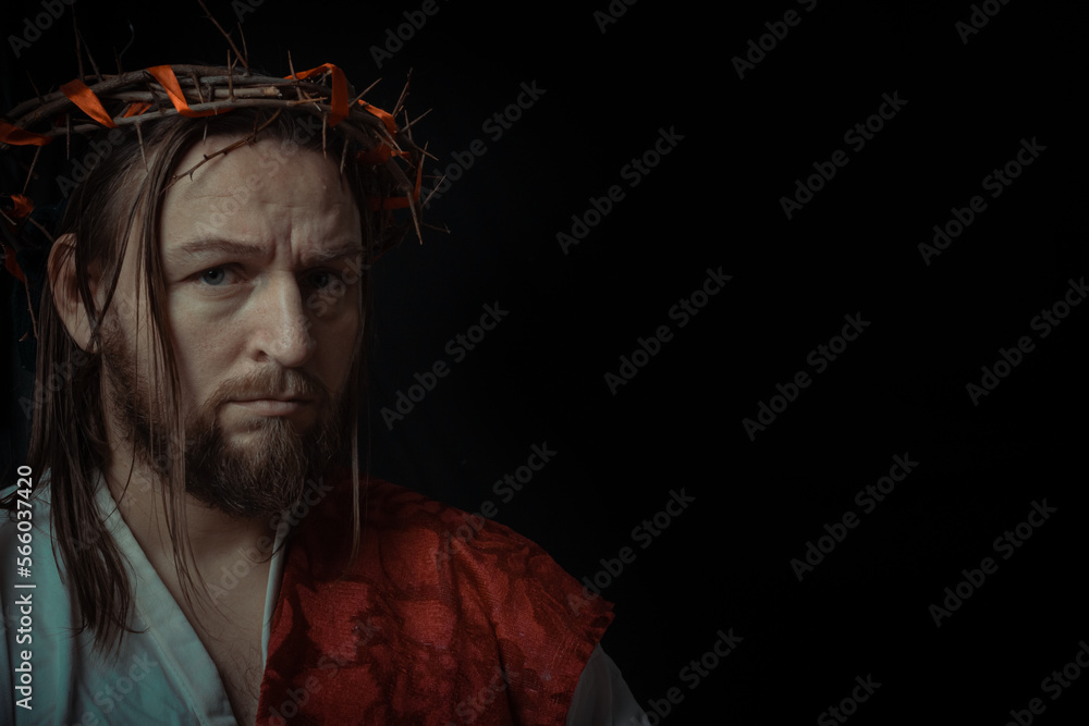 Fototapeta premium Jesus Christ wearing a crown of thorns and white chiton toga mantle cape himation suffering for mankind's sins in artistic mystical portrait