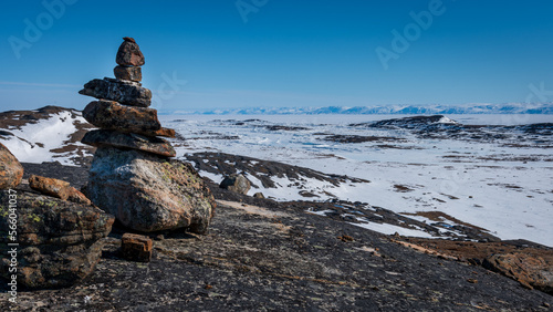 Inukshuk overlooking arctic landscape, Nunavut, Canada.
