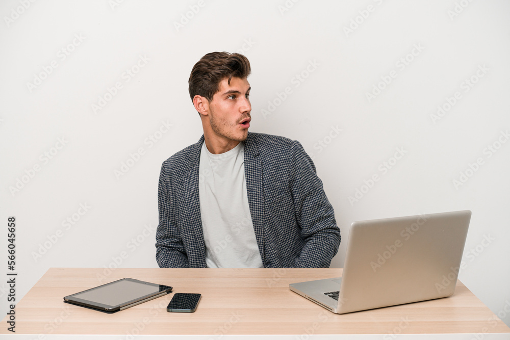 Young entrepreneur man working with a laptop isolated being shocked because of something she has seen. Young entrepreneur man working with a laptop isolated being shocked because of something she has seen.