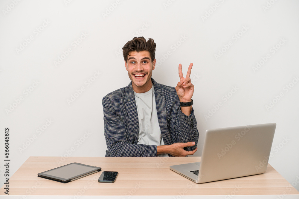 Young entrepreneur man working with a laptop isolated showing number two with fingers.