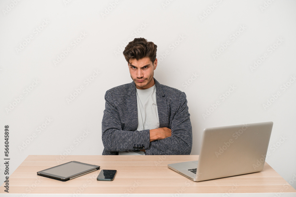 Young entrepreneur man working with a laptop isolated unhappy looking in camera with sarcastic expression. Young entrepreneur man working with a laptop isolated unhappy looking in camera with sarcastic expression.