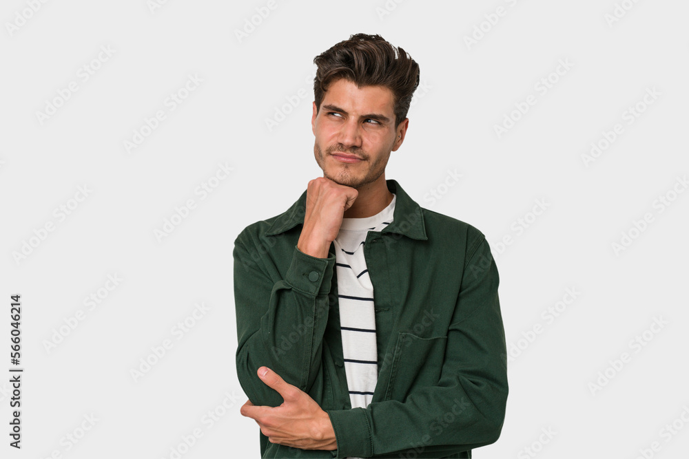 Young handsome caucasian man isolated on white background thinking and looking up, being reflective, contemplating, having a fantasy. Young handsome caucasian man isolated on white background thinking and looking up, being reflective, contemplating, having a fantasy.
