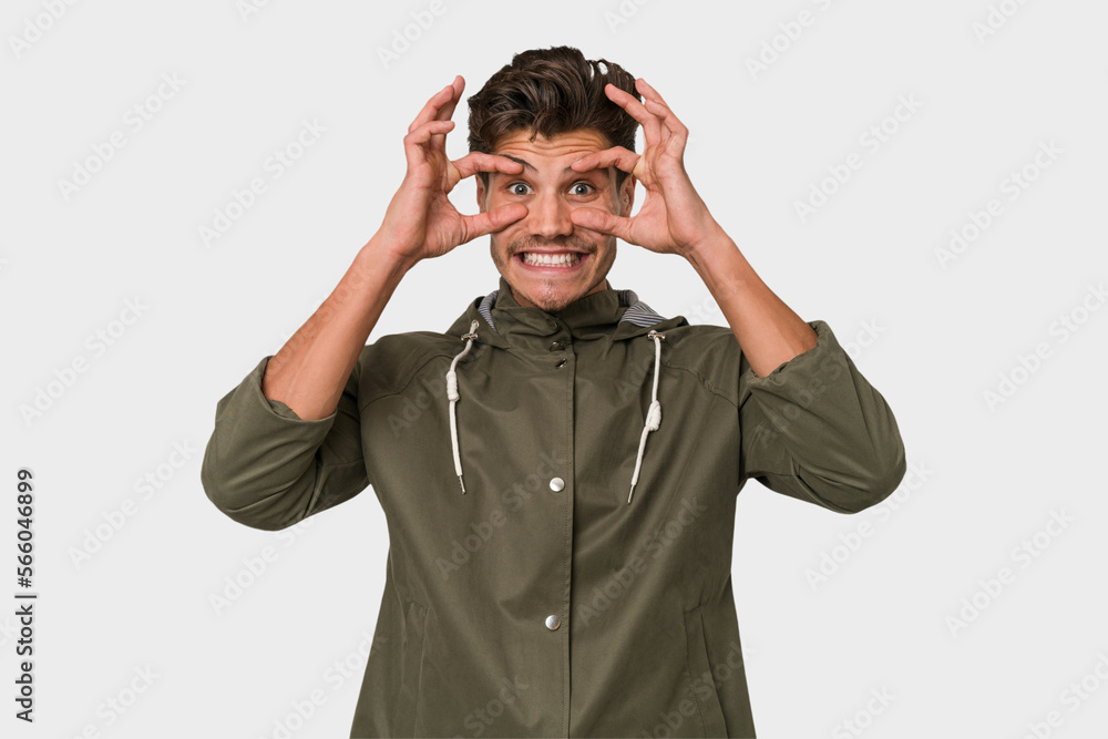Young handsome caucasian man isolated on white background keeping eyes opened to find a success opportunity. Young handsome caucasian man isolated on white background keeping eyes opened to find a success opportunity.