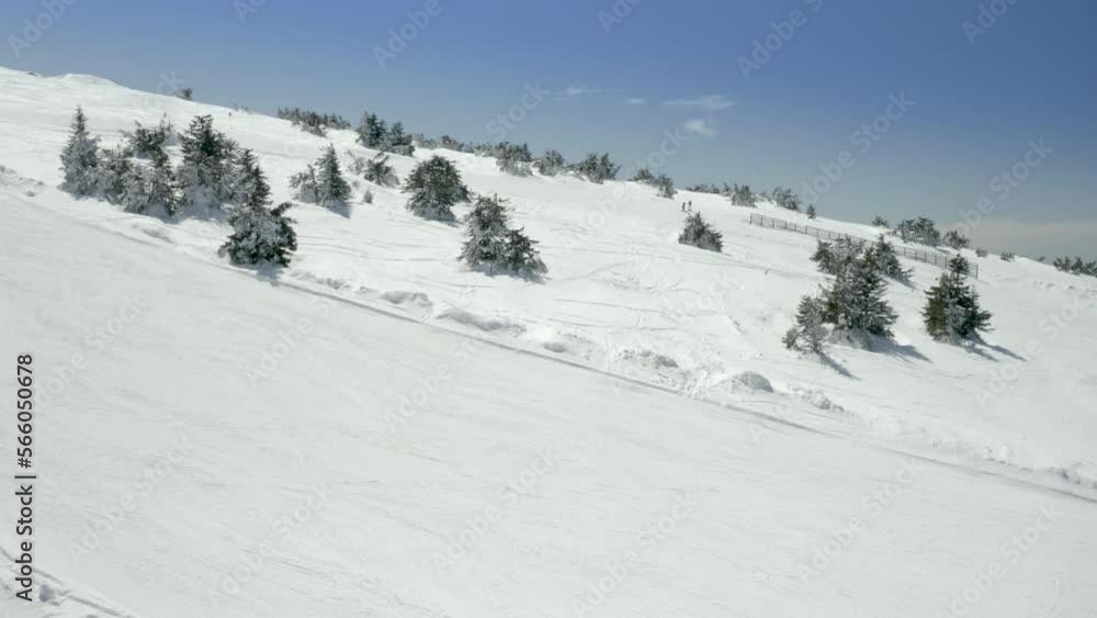 Aerial view of an athlete skies along snowy track on the ski slopes using technique of Telemark Aerial view of an athlete skies along snowy track on the ski slopes using technique of Telemark
