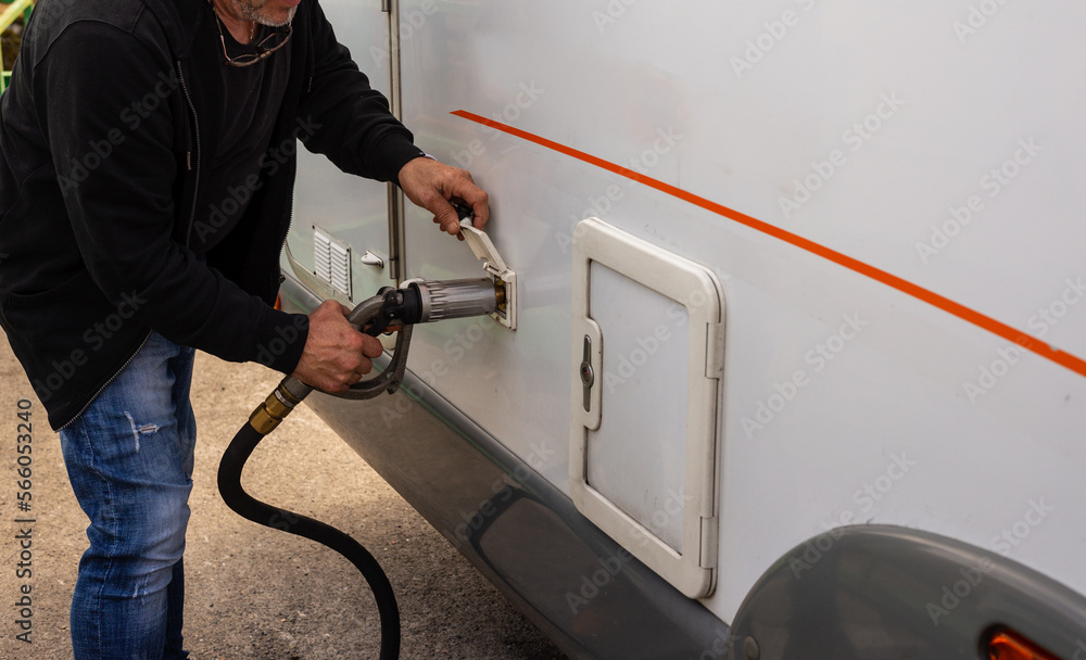 custom made wallpaper toronto digitalsenior man preparing to fill up the LPG tanks in his motor home