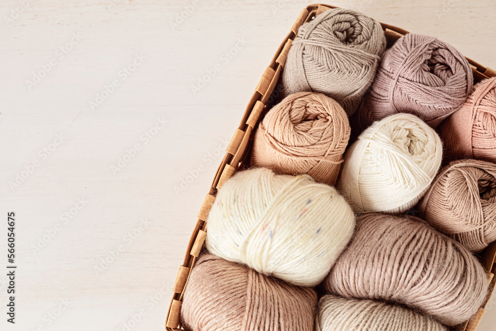 Craft knitting hobby background with yarn in natural colors. Recomforting hobby to reduce stress for cold fall and winter weather. Mock up, copy space, top view Craft knitting hobby background with yarn in natural colors. Recomforting hobby to reduce stress for cold fall and winter weather. Mock up, copy space, top view