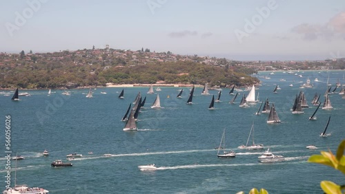 part of the fleet of smaller boats at the start of the sydney to hobart yacht race on sydney harbour, australia photo