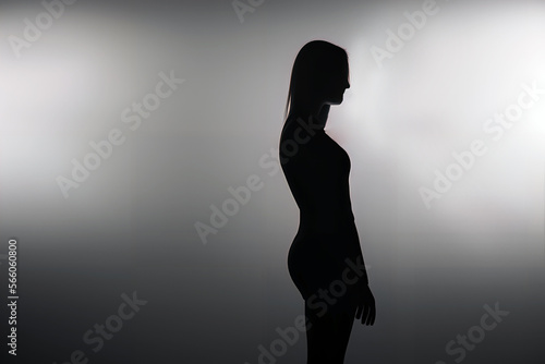 silhouette of a woman in dark, depression, hidden woman, artistic. 