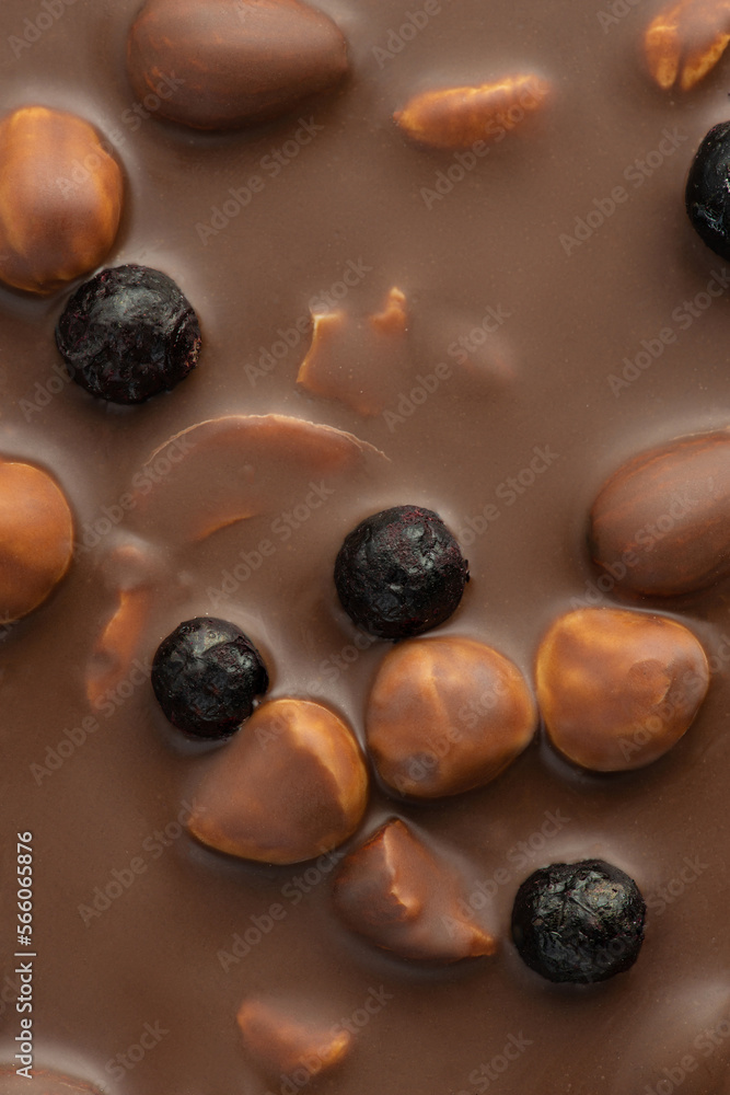 Texture of milk chocolate with nuts and berries
