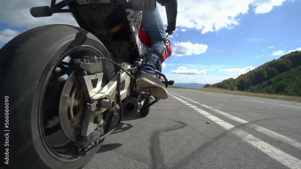 Stunt biker doing a doughnut, burnout on his motorcycle and making lots of smoke, slow motion Stunt biker doing a doughnut, burnout on his motorcycle and making lots of smoke, slow motion