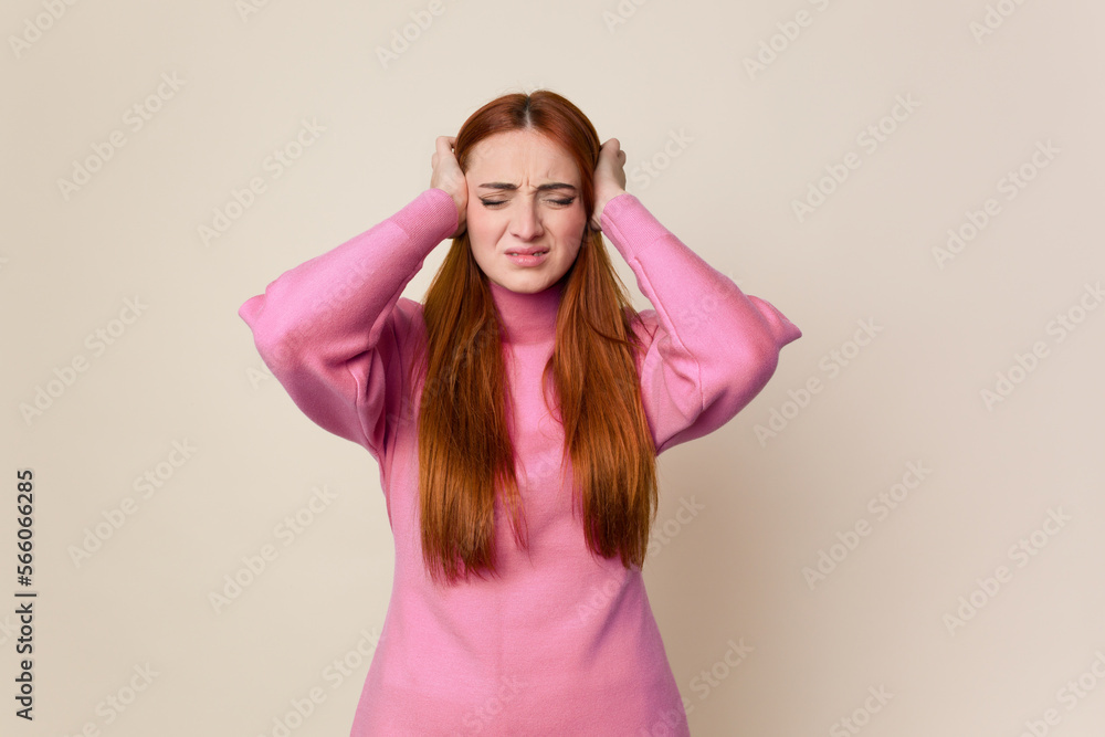 Young red hair woman isolated covering ears with hands. Young red hair woman isolated covering ears with hands.