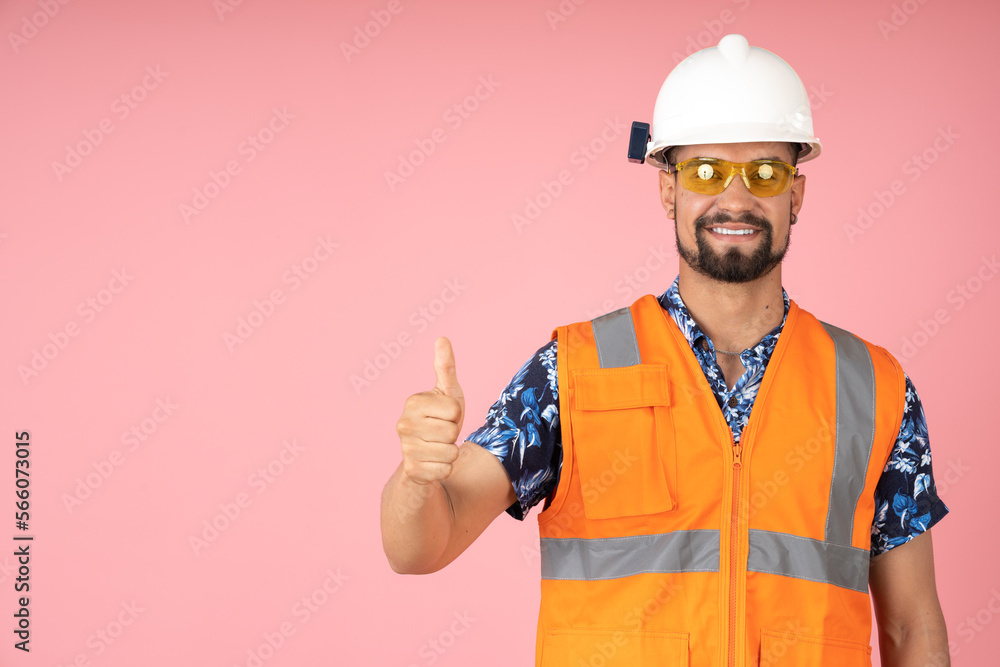 Worker with reflective vest, pointing his thumb up