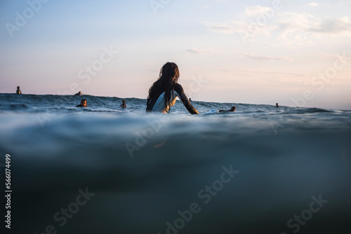 Young Woman waiting for Waves at Golden Hour