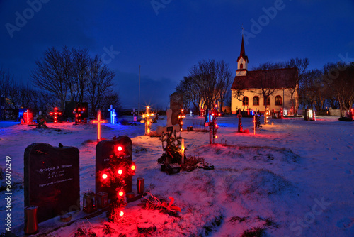 Christmas lights in graveyard of Kotstrandarkirkja Lutheran Church photo