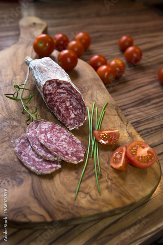 Close up of red sausage stick with tomatoes on a chopping board, Germany