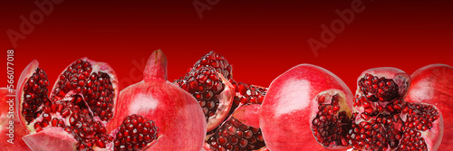 Juicy bright shiny pomegranate seeds on a red background