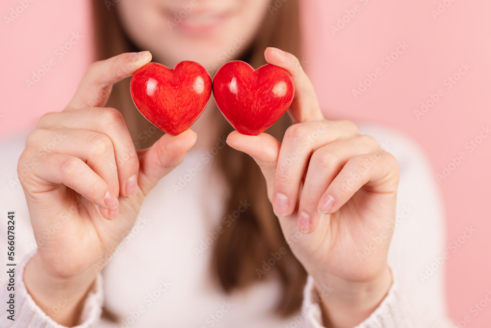 closeup hands holding heart on pink background, valentine's day concept closeup hands holding heart on pink background, valentine's day concept
