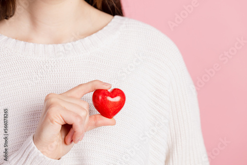 Fototapeta Naklejka Na Ścianę i Meble -  closeup hands holding heart on pink background, valentine's day concept