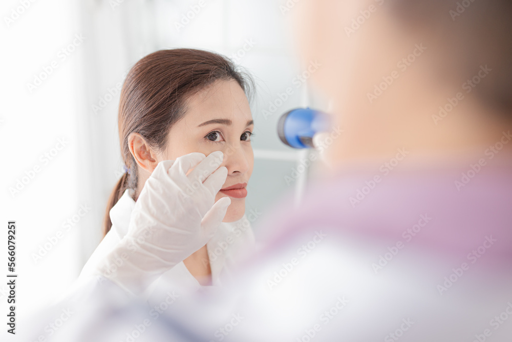 doctor use flashlight screening conjunctivitis patient, asian patient has red eyes and feeling pain, infection eye doctor use flashlight screening conjunctivitis patient, asian patient has red eyes and feeling pain, infection eye