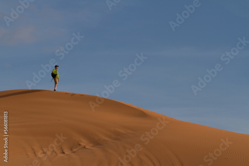 A man looks out over the sand dunes at Coral Pink Sand Dunes State Park in Utah