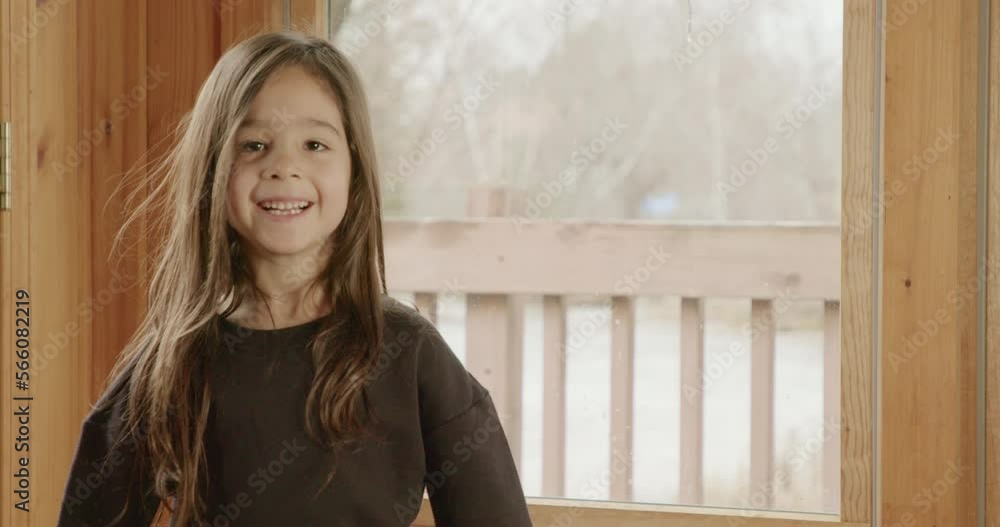A small Latina girl practices ballet in her living room. A small Latina girl practices ballet in her living room.