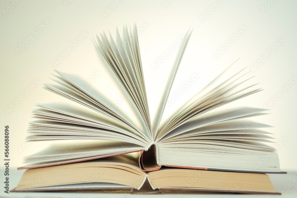 stack of books on a wooden table.Reading books.Open books on a light background with a yellow gradient. Learning and knowledge symbol.Reading and education.Literature and reading concept. stack of books on a wooden table.Reading books.Open books on a light background with a yellow gradient. Learning and knowledge symbol.Reading and education.Literature and reading concept.