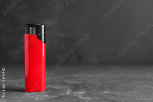 Stylish small pocket lighter on grey table, space for text