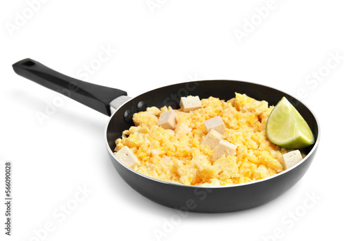 Frying pan with delicious scrambled eggs, tofu and lime isolated on white