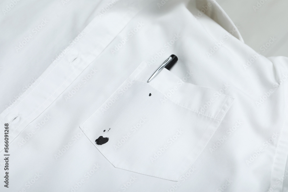 Pen and stain of black ink on white shirt, closeup Pen and stain of black ink on white shirt, closeup