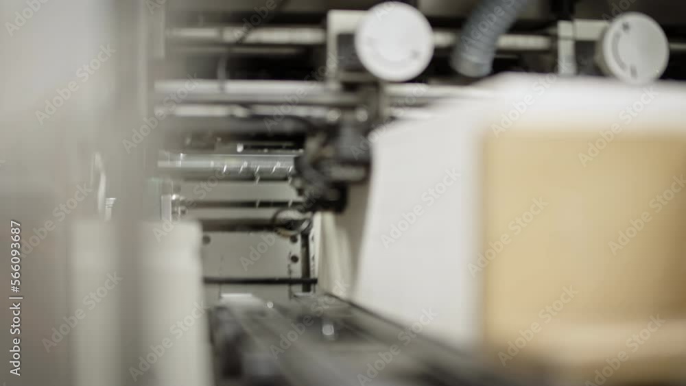 Close up shot of inside of a printing machine, closing and opening, paper fast traveling past the opening. Close up shot of inside of a printing machine, closing and opening, paper fast traveling past the opening.