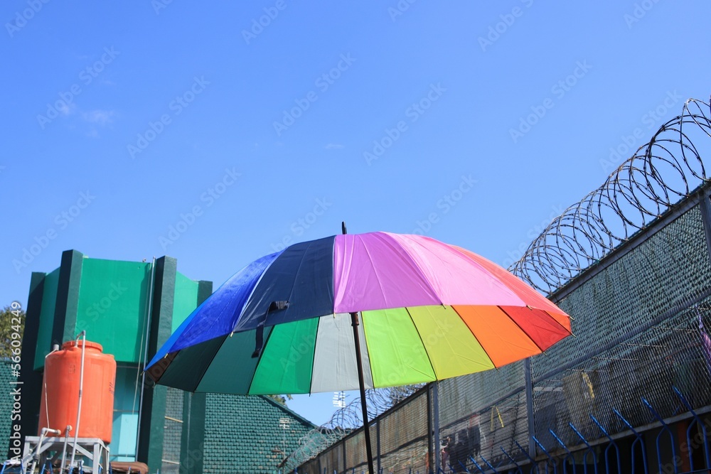 The colorfull umbrella under cloud dark blue sky.
