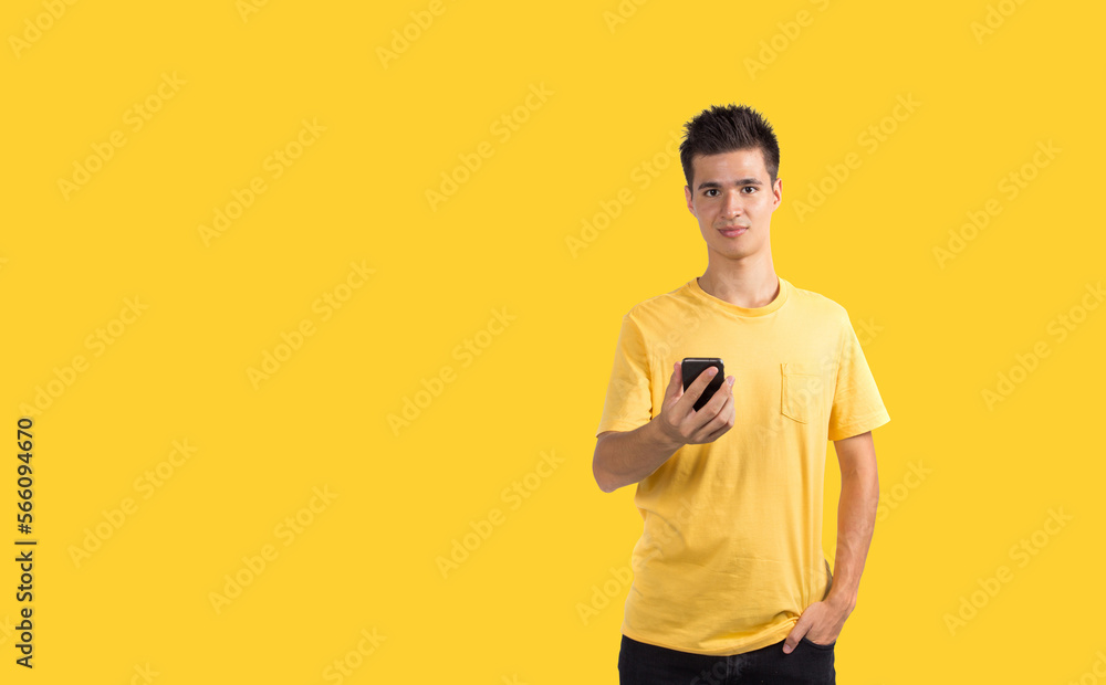 Teenage boy using smart phone, isolated on blue background Teenage boy using smart phone, isolated on blue background