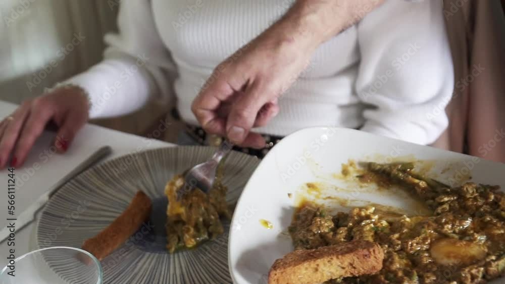 Slowmotion shot of Spanish food being dished out and served onto a plate Slowmotion shot of Spanish food being dished out and served onto a plate