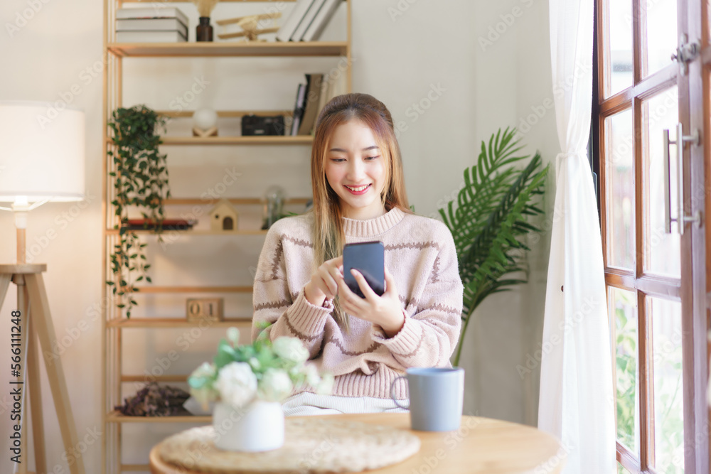 Leisure time concept, Women use smartphone to surfing social media while relaxation in living room Leisure time concept, Women use smartphone to surfing social media while relaxation in living room