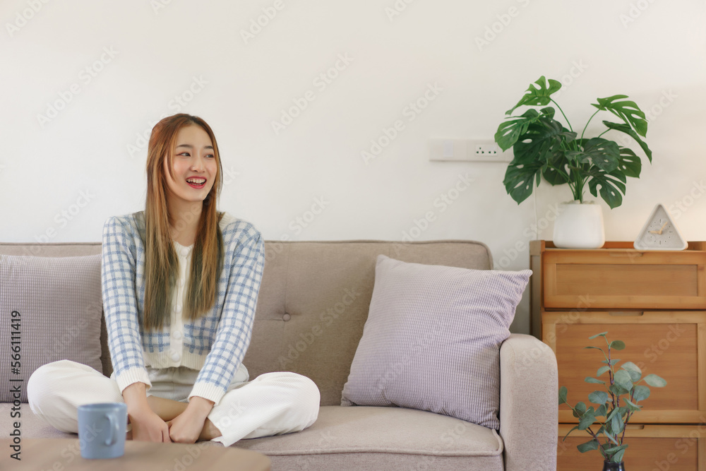 Rest time concept, Women is sitting on comfortable the couch to spending relax time with happiness Rest time concept, Women is sitting on comfortable the couch to spending relax time with happiness