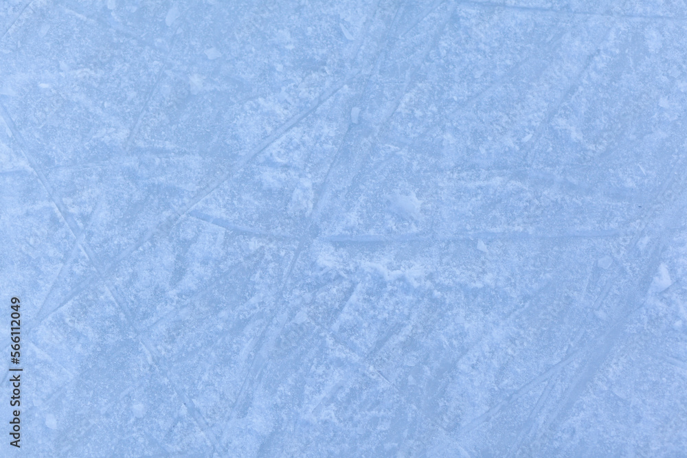 Empty ice rink with skate marks after the session outdoor. skating ice rink texture covered with snow in daylight. Close up of blue ice rink floor, copy space Empty ice rink with skate marks after the session outdoor. skating ice rink texture covered with snow in daylight. Close up of blue ice rink floor, copy space