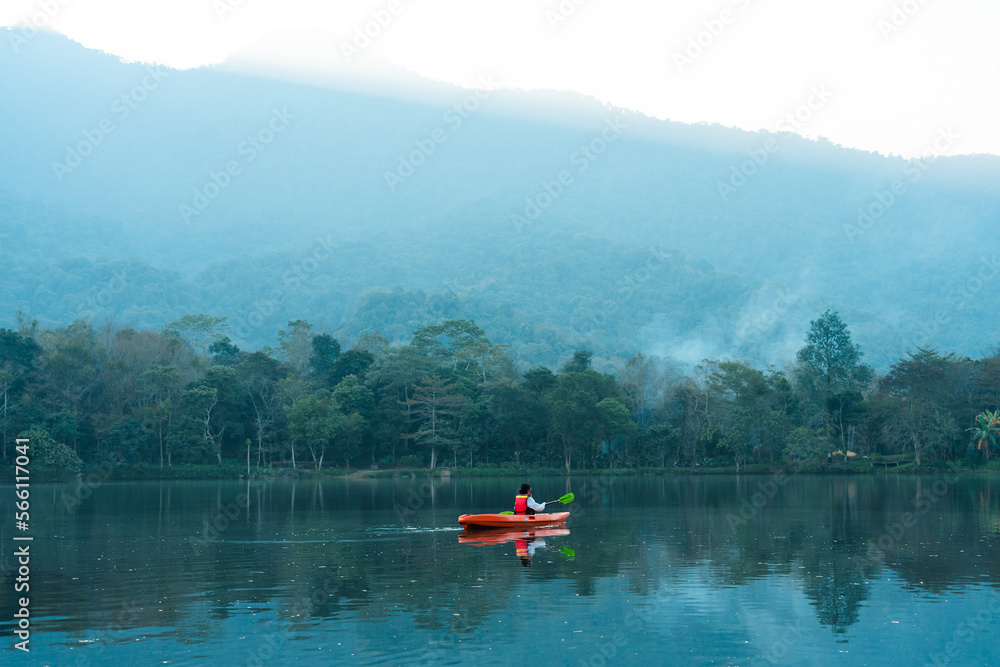 image of a person kayaking on a lake