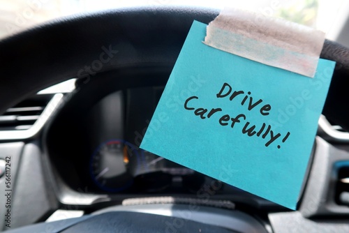 Slika na platnu A blue paper note sticking on the car steering wheel, with text written DRIVE CA